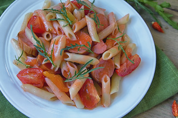 Penne pasta in tomato sauce with sauseges, tomatoes and sweet pepper.