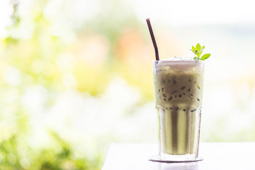 ice green tea with milk on wooden table