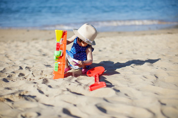 baby girl playing at summer beach