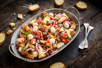 Served and prepared healthy salad with vegetables,baked bread and mozzarella,selective focus