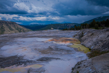 Yellowstone National Park, USA - May 17, 2016: Mammoth hot springs pools with hiking trails and Albright visitor center