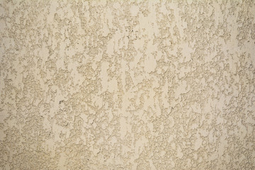 texture of the coarse surface of the wall covered with decorative plaster of the woodworm type