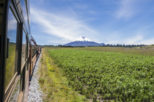 A view from the window of the famous 'Train of the Volcanoes' route that passes near many active volcanoes in Ecuador. In the picture is the Cotopaxi volcano to be seen in a sunny day.
