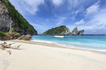 Small waves crash at the end of Atuh Beach in Nusa Penida, a small island near Bali, Indonesia.