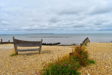Lovely sea view. Bench and flowers in bloom. Whitstable central beach. Whitstable, Kent, UK