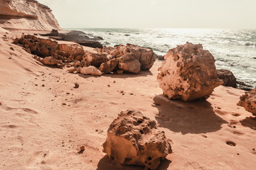 nature poster. yellow sand rock and blue ocean