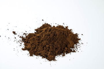 Pile of grounded coffee on a white background