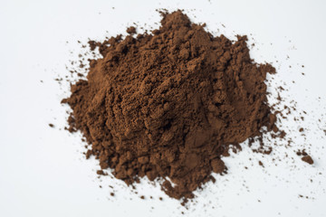 Pile of grounded coffee on a white background