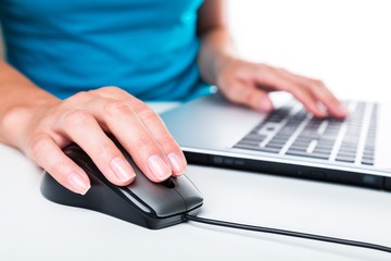 Closeup of an Employee Typing on a Keyboard and Holding Mouse