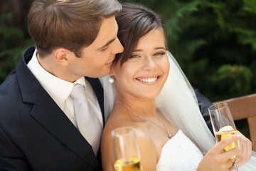 Portrait of a Smiling Wedding Couple Holding Champagne Glasses