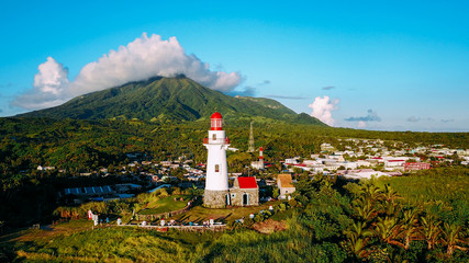 Fototapeta na wymiar Basco lighthouse and Mount Iraya of Basco City, Batan island in the province of Batanes, Philippines
