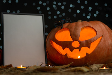 Pumpkin with candles and a frame for writing. Halloween