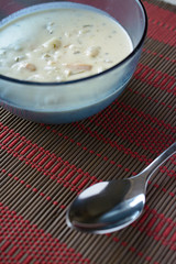 Clam chowder in dish with spoon