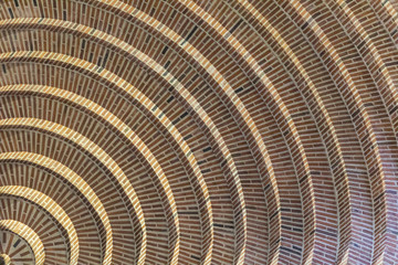 Circle lines at the top of a church making an amazing brick textured pattern like a spiral going to the infinite