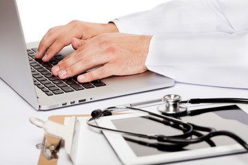 Closeup of Doctor Typing on Laptop