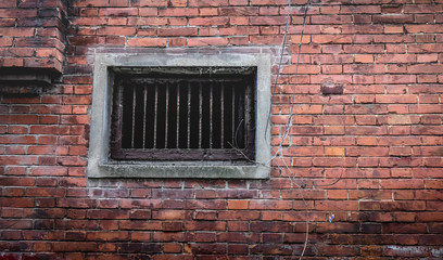 Fototapeta na wymiar Security Bars On Old Window In Brick Wall.