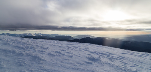 Naklejka na ściany i meble Winter alpine scenery with fresh snow, mist, and beautiful evening light