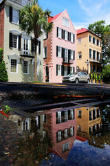 Street view with colorful buildings reflected in a puddle after the rain at the historic downtown area city of Charleston, South Carolina, USA. Southern style architecture background.