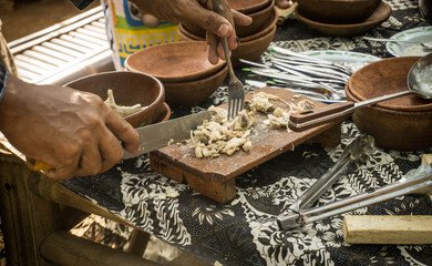 a chicken slice on wooden board seller on traditional market