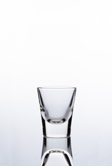Clear shot glass on a white background
