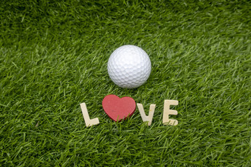 To golfer with love on Valentine's day with golf ball on green grass
