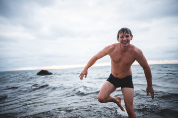 Fototapeta premium Man Wades in Ocean