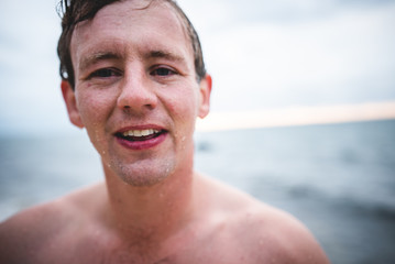 Wet Man Smiling Near Ocean