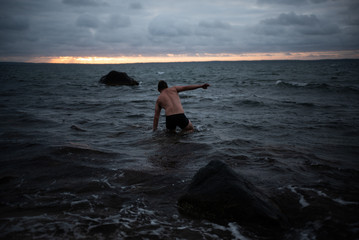 Fototapeta premium Man Wading in Water