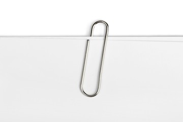 Metal paper clip isolated on white