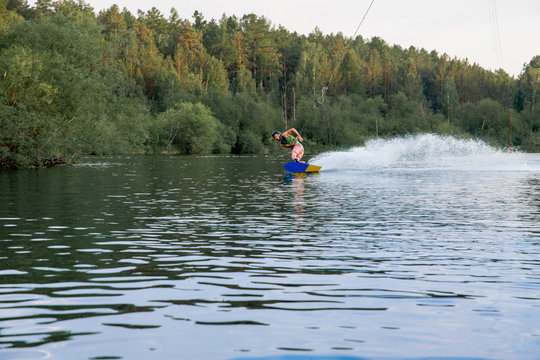 Young man riding wakeboard on a lake