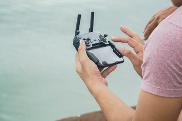 close up man play mobile Drone by remote control joystick with smartphone © jummie