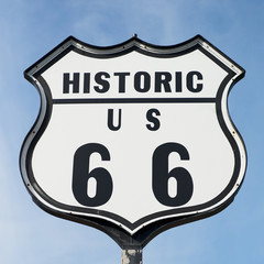 Black and White Historic Route 66 Road Sign against Blue Sky
