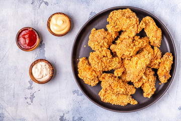 Fried chicken wings with various sauces.