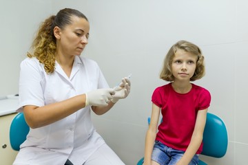 Doctor with syringe. Vaccination of a child in hospital. Medicine, healthcare, pediatry and people...