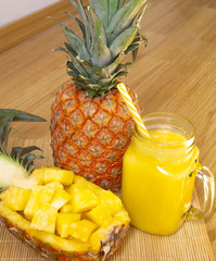 Still life. Pineapple juice, smoothies with fresh pineapple for breakfast in the morning on a...