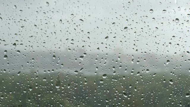 Drop flows down on a window in a rain