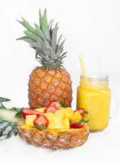 Still life. Pineapple juice, cocktails with fresh pineapple and fresh strawberries for breakfast in the morning, on a white background. Detox. For health and for weight loss.