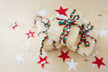 Christmas gifts in Kraft to packing on a wooden background