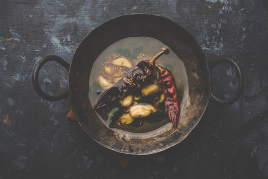 chaunk / Tadka / Tempering spices also known as baghaara, fodni, tarka or vaghaar. Typically prepared in Iron Karahi/kadhai. selective focus