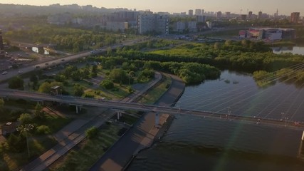 Footbridge over the flow of the Yenisei river in Krasnoyarsk sunny drone footage