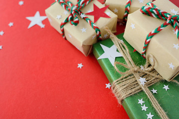 Christmas gifts packed into Kraft paper on a red background