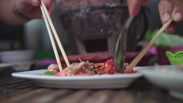 Eating Thai sea food Som Tam, spicy papaya salad