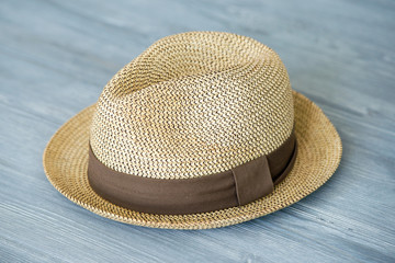 Vintage straw hat fashion for man, against a background of gray wooden boards