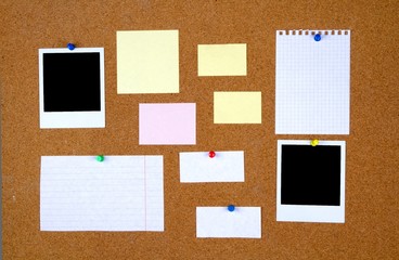 Bulletin board with with blank notes and photographs