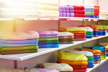 Colored terry towels on shop shelves