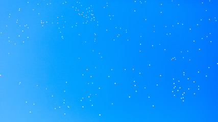 Fototapeta premium White balls flying in the blue sky