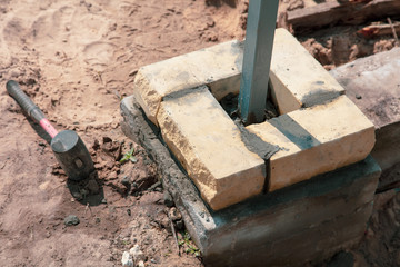 The worker lays bricks on the construction site