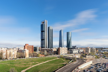 Fototapeta na wymiar Madrid cityscape at daytime. Landscape of Madrid business building at Four Tower. Modern high building in business district area at Spain.