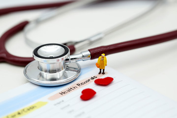Miniature people : Doctor and patient Cardiogram with stethoscope and red heart,A heart beats graph...