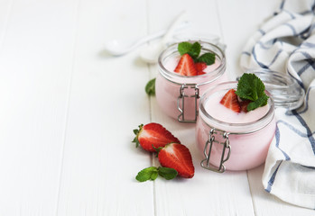 Jars with strawberry yogurt